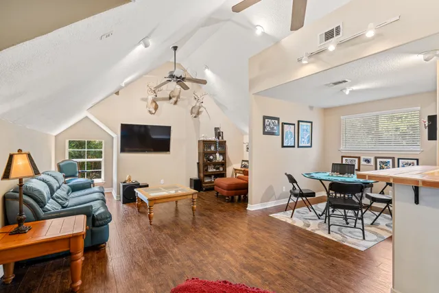 a living room with furniture and wooden floor