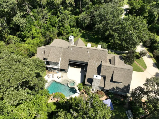 an aerial view of a house with yard and outdoor seating