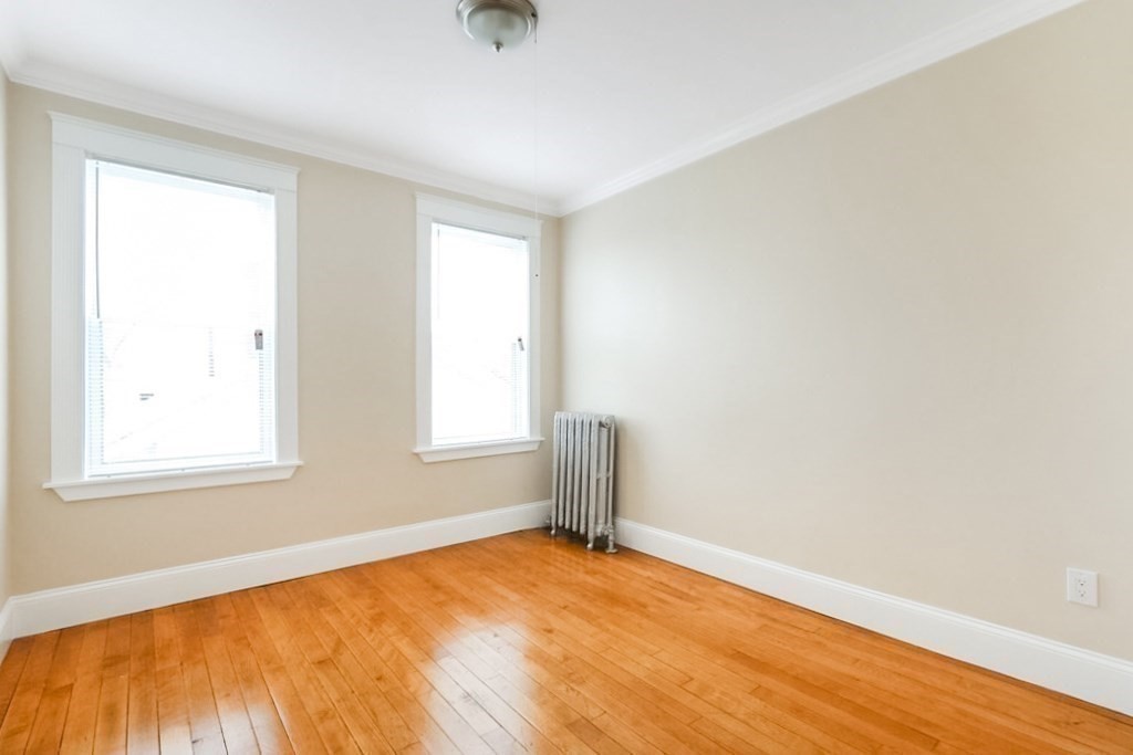 71 Walnut Park Boston, MA 02119 - Photo 13 of 36 an empty room with a window