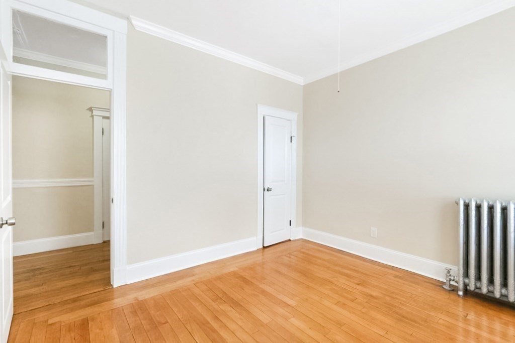 71 Walnut Park Boston, MA 02119 - Photo 14 of 36 a view of empty room with wooden floor