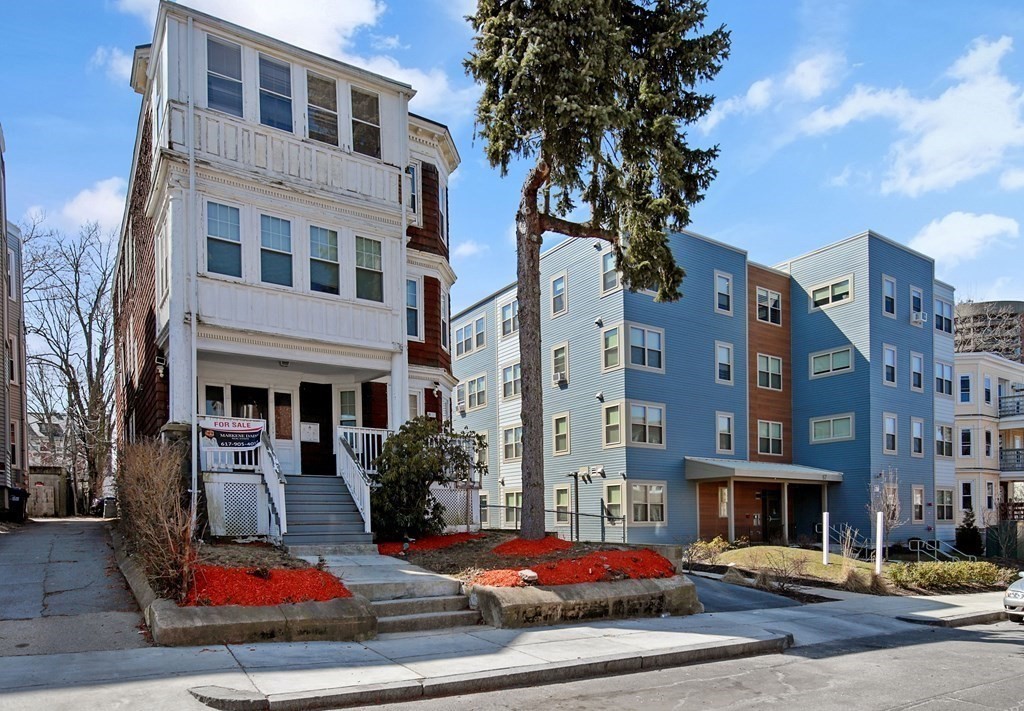 71 Walnut Park Boston, MA 02119 - Photo 2 of 36 a view of a building with many windows