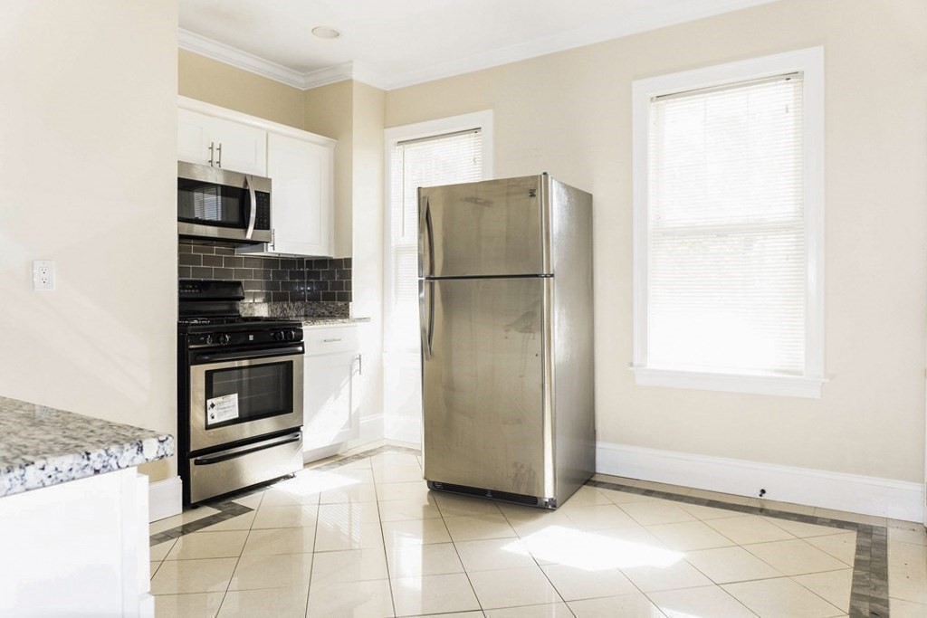 71 Walnut Park Boston, MA 02119 - Photo 25 of 36 a kitchen with a refrigerator sink and microwave