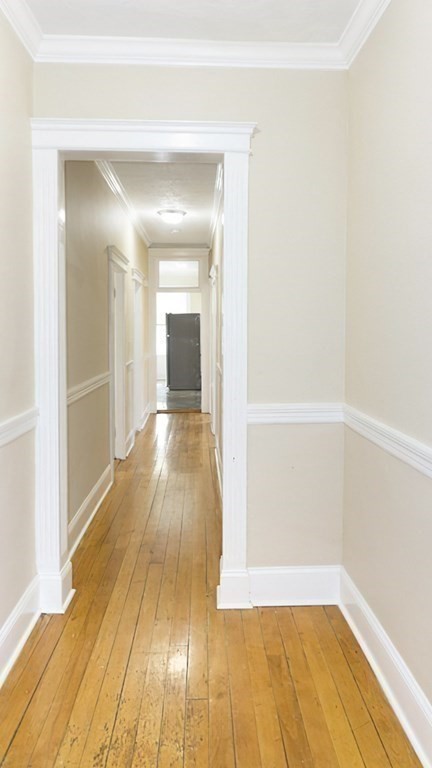 71 Walnut Park Boston, MA 02119 - Photo 26 of 36 a view of a room with wooden floor and a bathroom