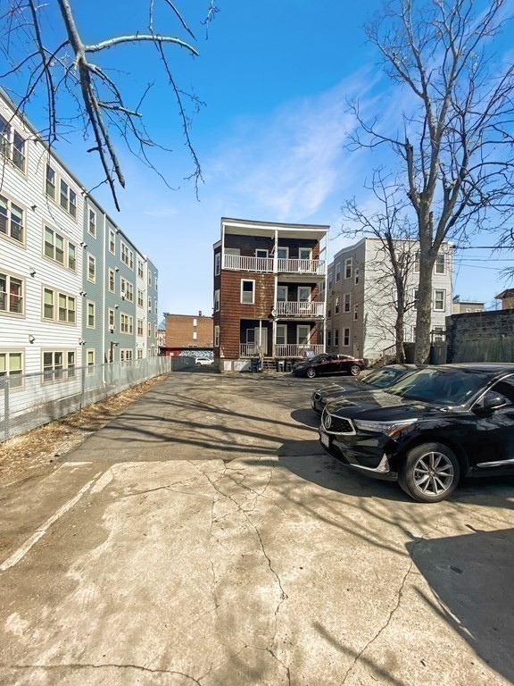 71 Walnut Park Boston, MA 02119 - Photo 33 of 36 a car parked in front of a building