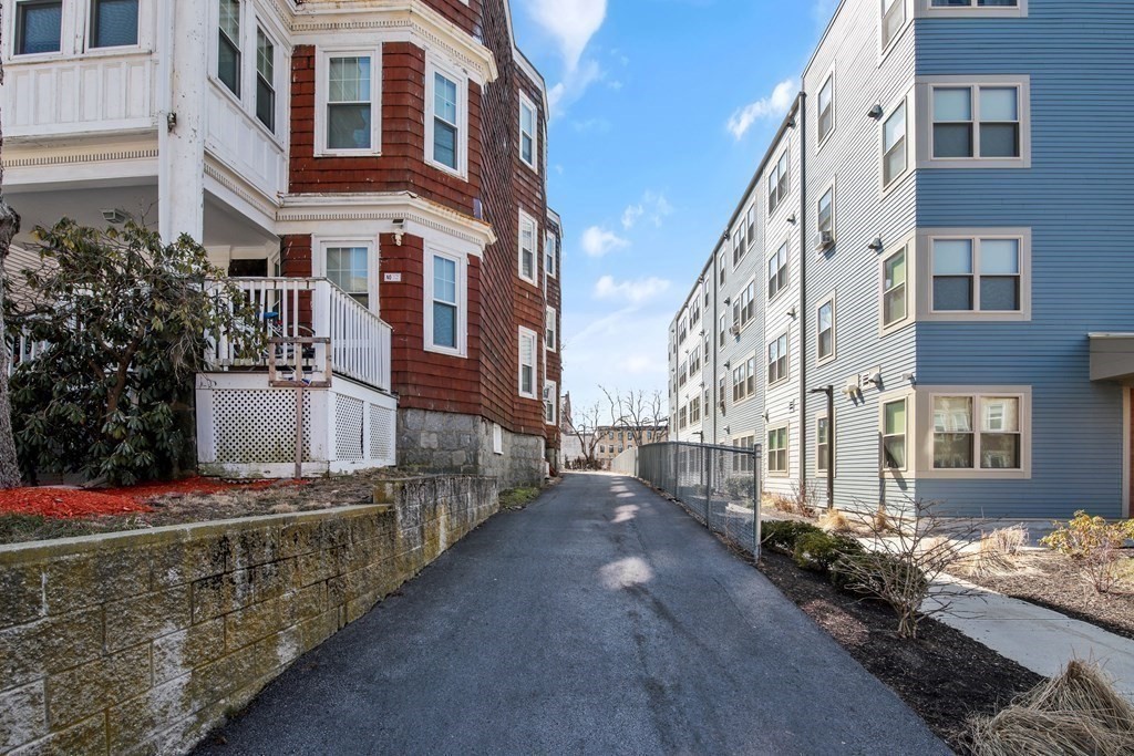 71 Walnut Park Boston, MA 02119 - Photo 4 of 36 a view of a large building with many windows