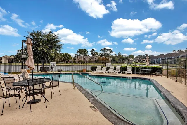 a view of a swimming pool with outdoor seating