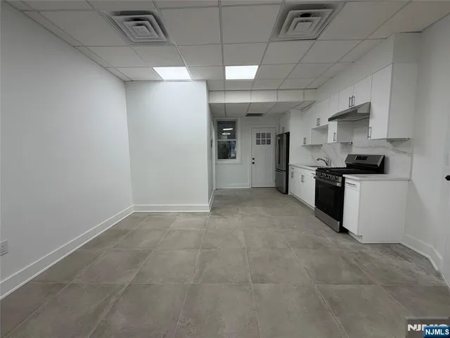 a large kitchen with cabinets and stainless steel appliances