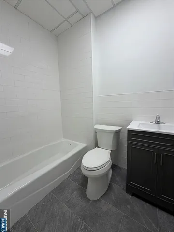 a white toilet sitting next to a bath tub