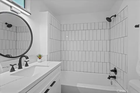 a living room with hardwood floor and a large window