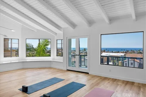 a bedroom with a bed and a large mirror