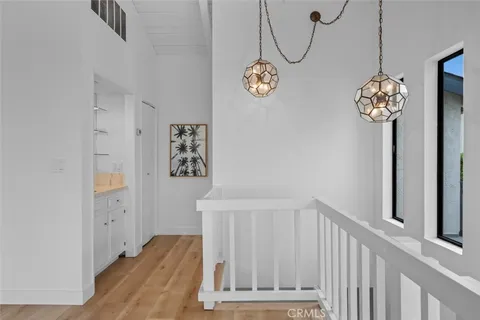 an aerial view of a city with lots of residential buildings and ocean view in back