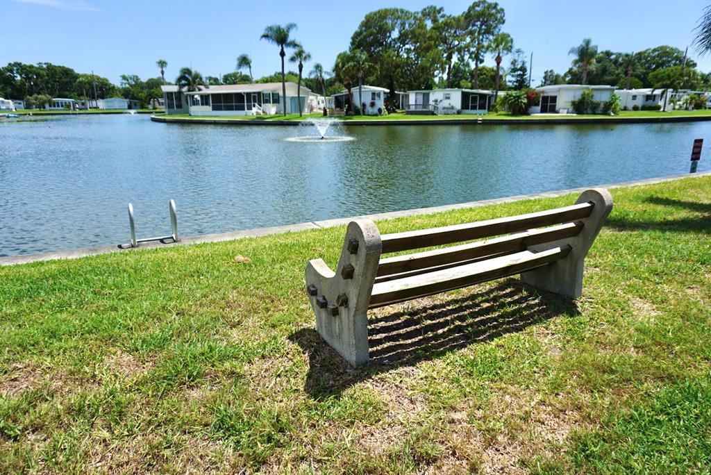 980 7th Street Northwest, Unit 71 Largo, FL 33770 - Photo 22 of 23 a view of a lake with houses in the back