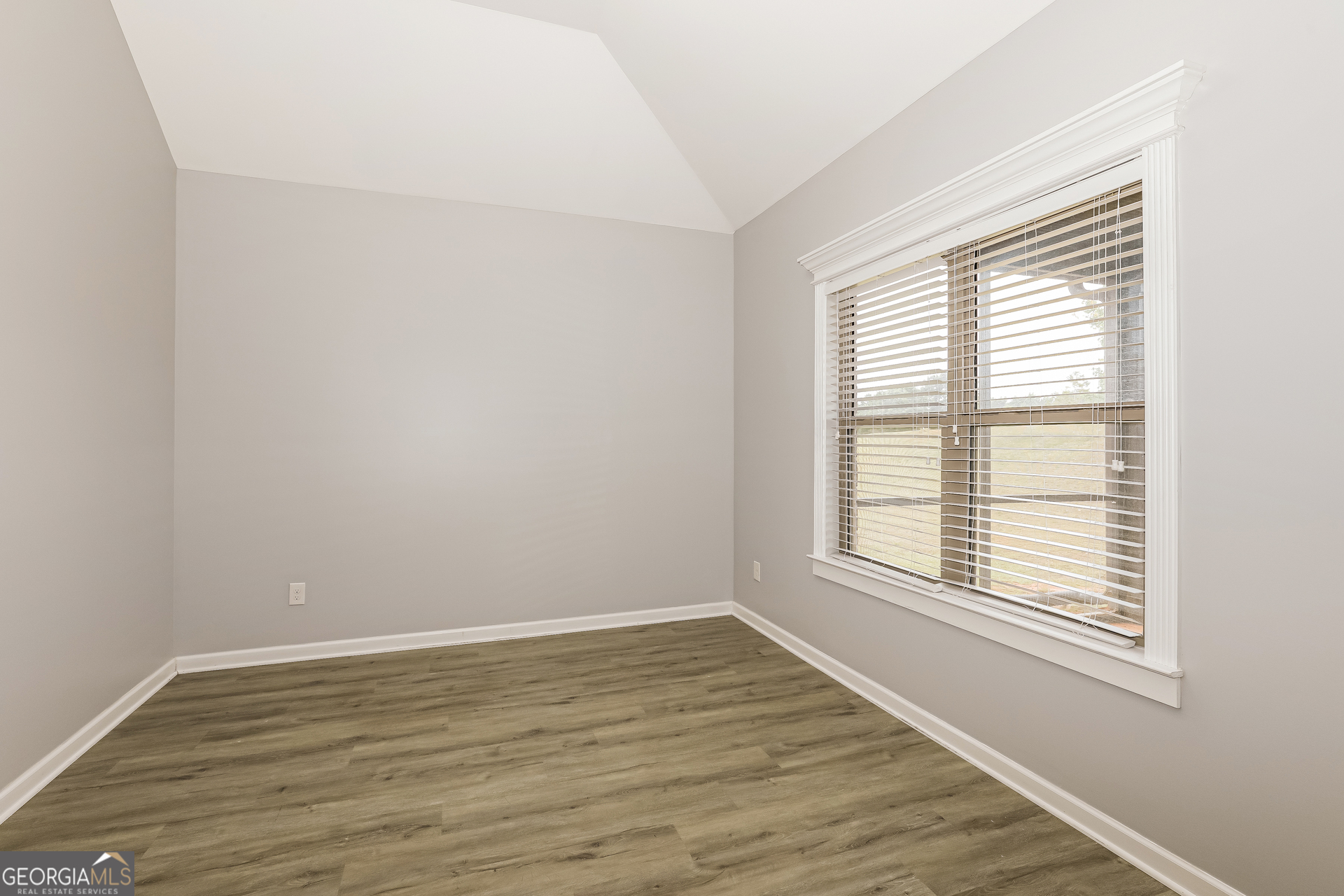 3216 Alhambra Circle Hampton, GA 30228 - Photo 3 of 21 a view of an empty room with wooden floor and a window
