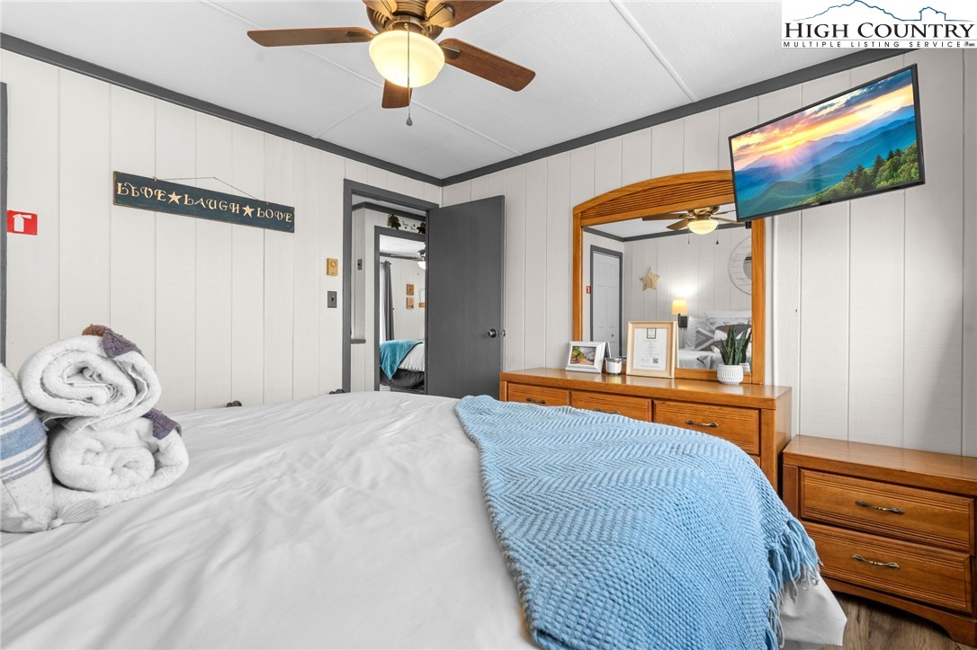 220 Charter Hills Road, Unit C2 Beech Mountain, NC 28604 - Photo 17 of 26 a bedroom with a bed and a chandelier