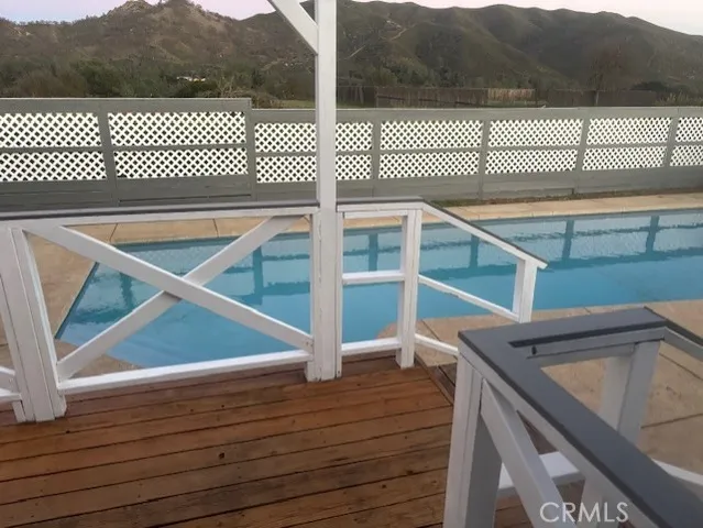 a view of a balcony with wooden floor