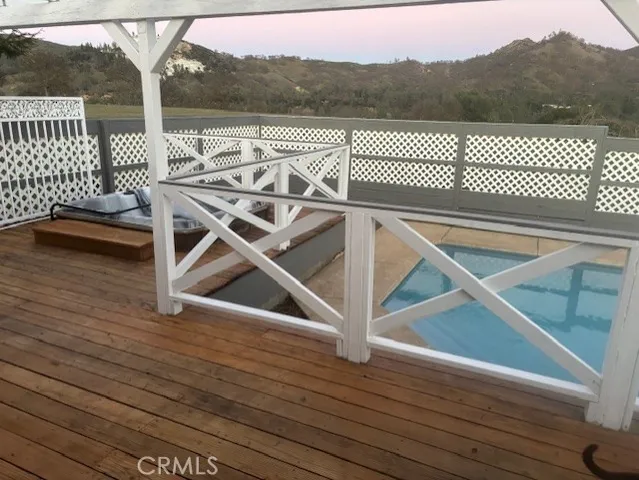 a view of a roof deck with wooden fence