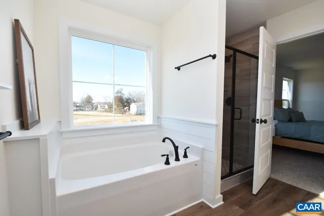 a bathroom with a tub and a window