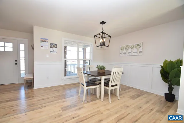 a view of a dining room with furniture wooden floor and chandelier