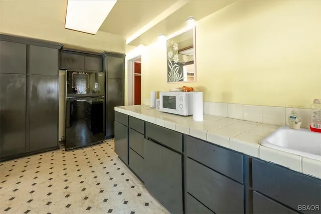 a bathroom with a sink a large mirror and a shower