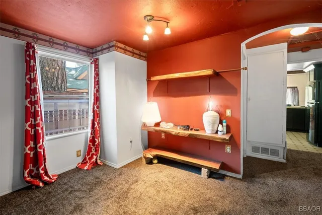 a room with a mirror and a lamp