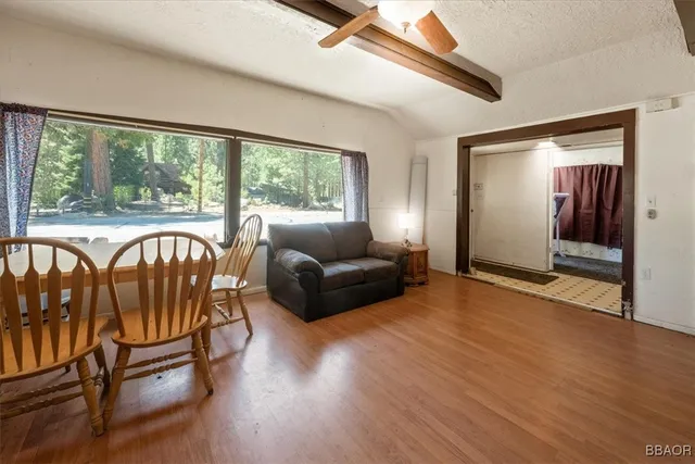 a living room with furniture and a floor to ceiling window