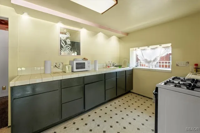 a bathroom with a sink mirror and a shower