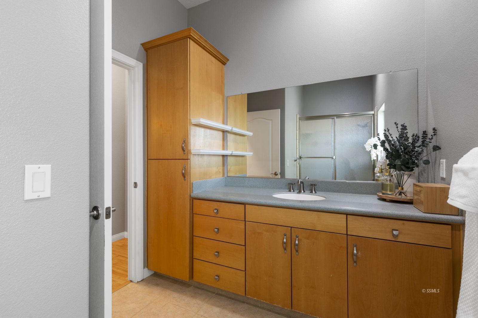 107 Brianna Street Ridgecrest, CA 93555 - Photo 41 of 50 a bathroom with a granite countertop sink a mirror and a shower