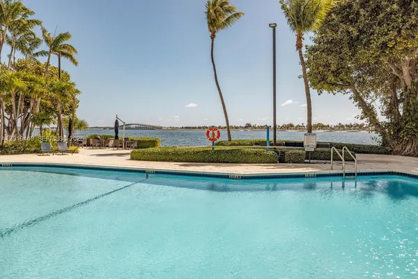 a view of a swimming pool with outdoor seating