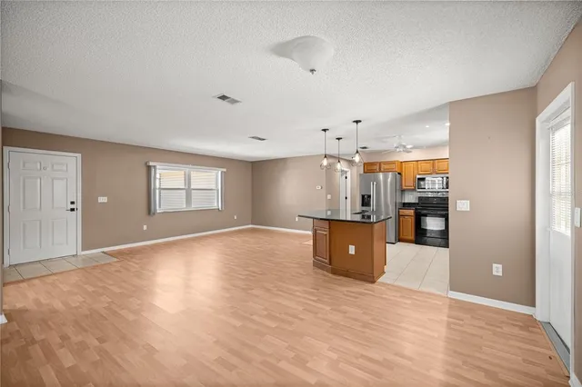 a kitchen with stainless steel appliances granite countertop a sink a stove and a refrigerator