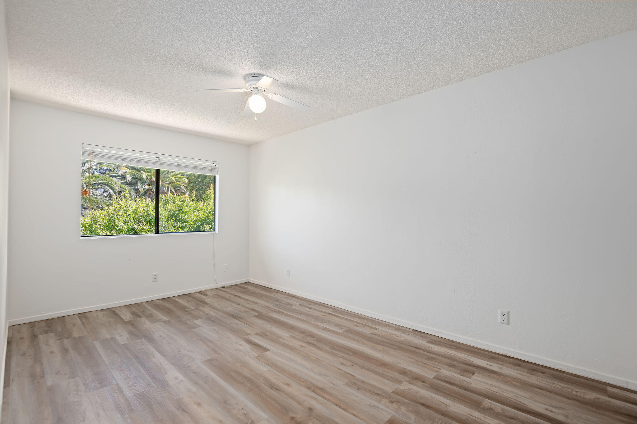 1676 Maple Avenue, Unit 4 Solvang, CA 93463 - Photo 11 of 16 wooden floor in an empty room with a window