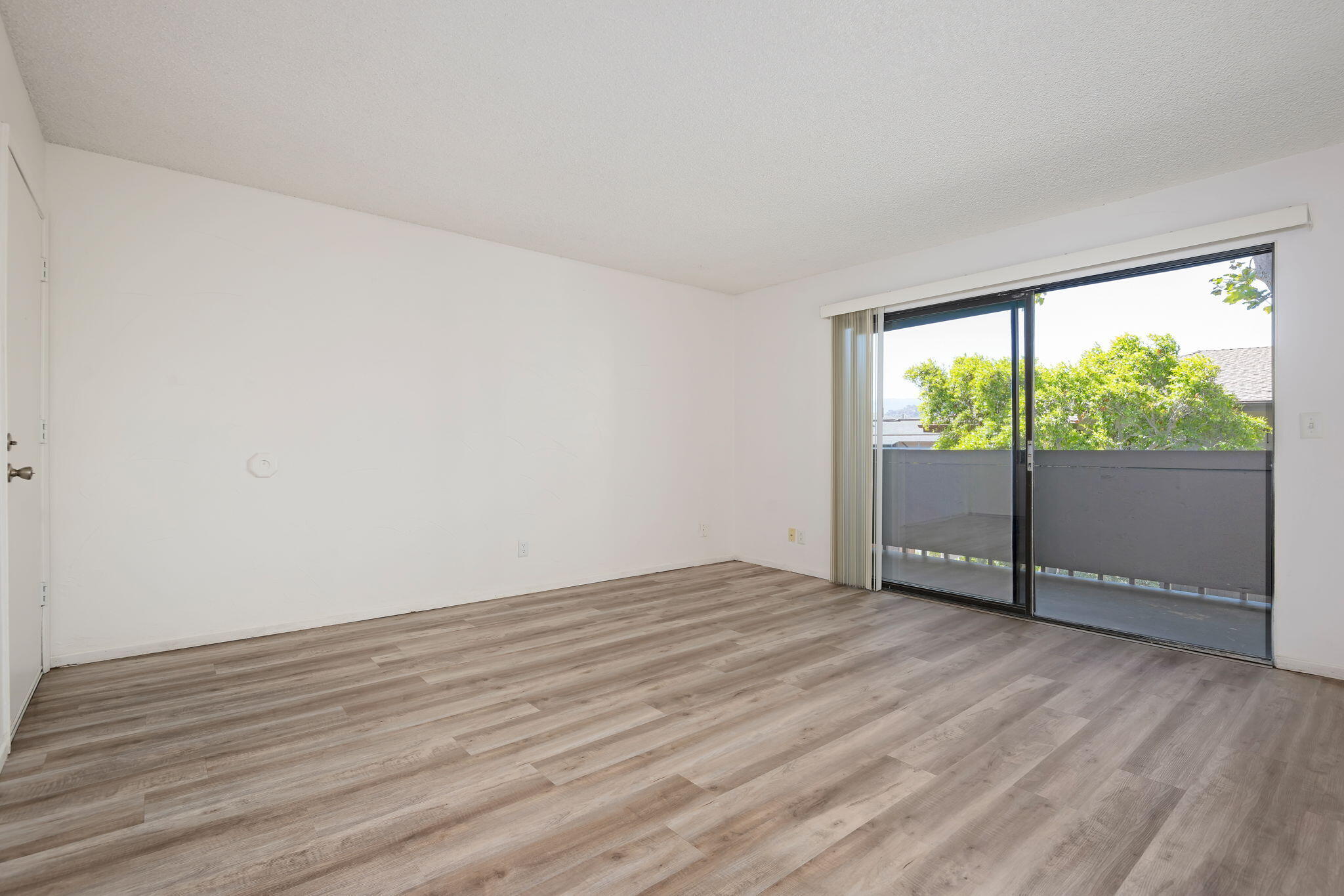 1676 Maple Avenue, Unit 4 Solvang, CA 93463 - Photo 12 of 16 a view of an empty room with wooden floor and a window