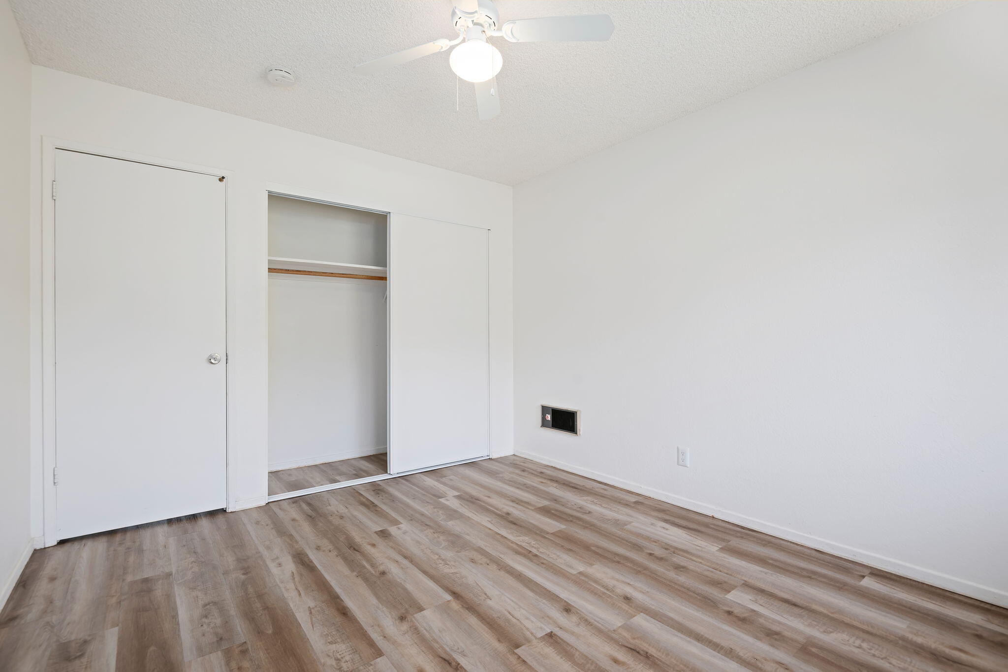 1676 Maple Avenue, Unit 4 Solvang, CA 93463 - Photo 13 of 16 a view of empty room with wooden floor and fan