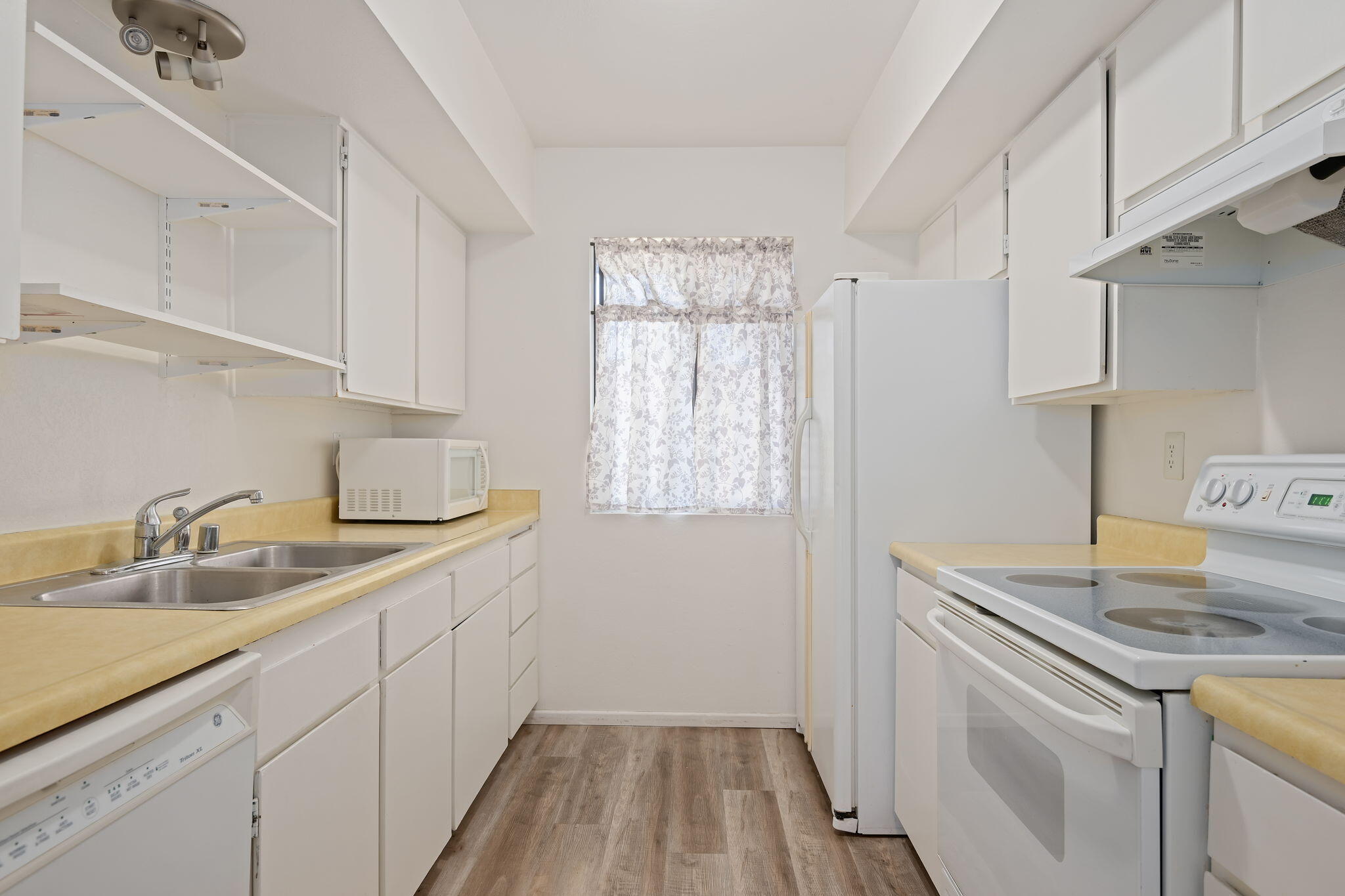 1676 Maple Avenue, Unit 4 Solvang, CA 93463 - Photo 3 of 16 a kitchen with a sink stove and cabinets