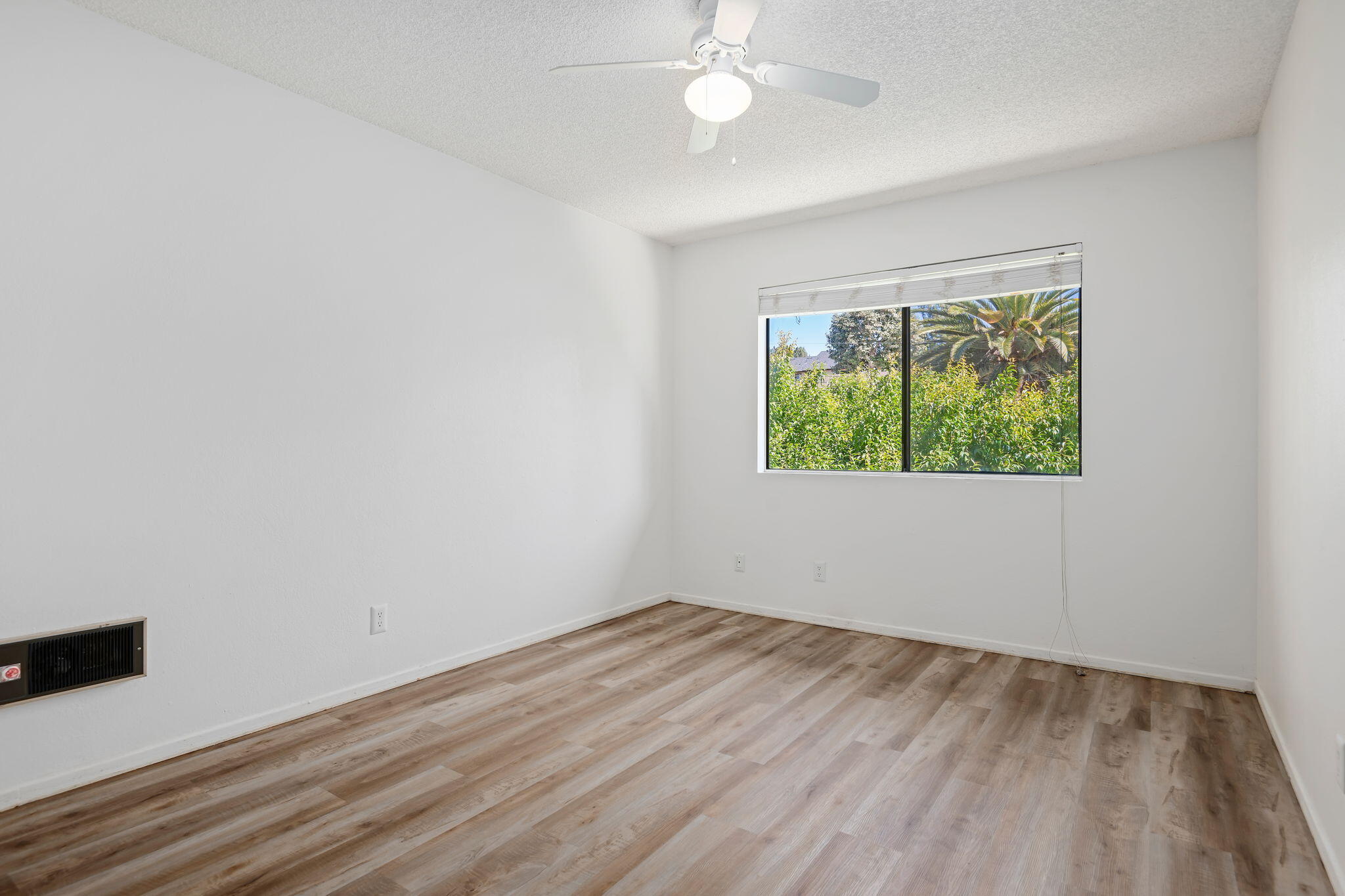 1676 Maple Avenue, Unit 4 Solvang, CA 93463 - Photo 7 of 16 wooden floor in an empty room with a window