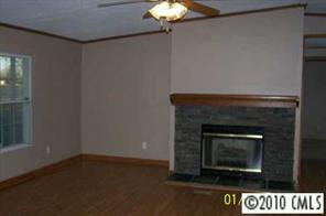 2823 Price Rushing Road Monroe, NC 28110 - Photo 5 of 6 a living room with a fireplace