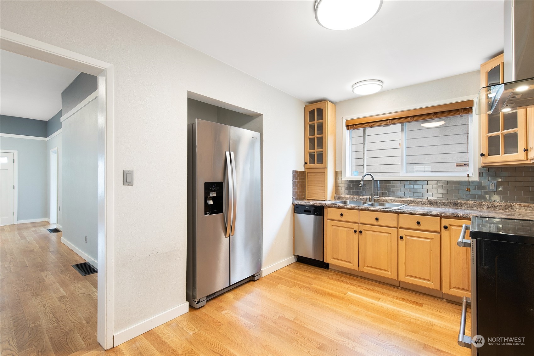 2934 Cedar Street Everett, WA 98201 - Photo 17 of 35 a kitchen with granite countertop stainless steel appliances a sink and a refrigerator