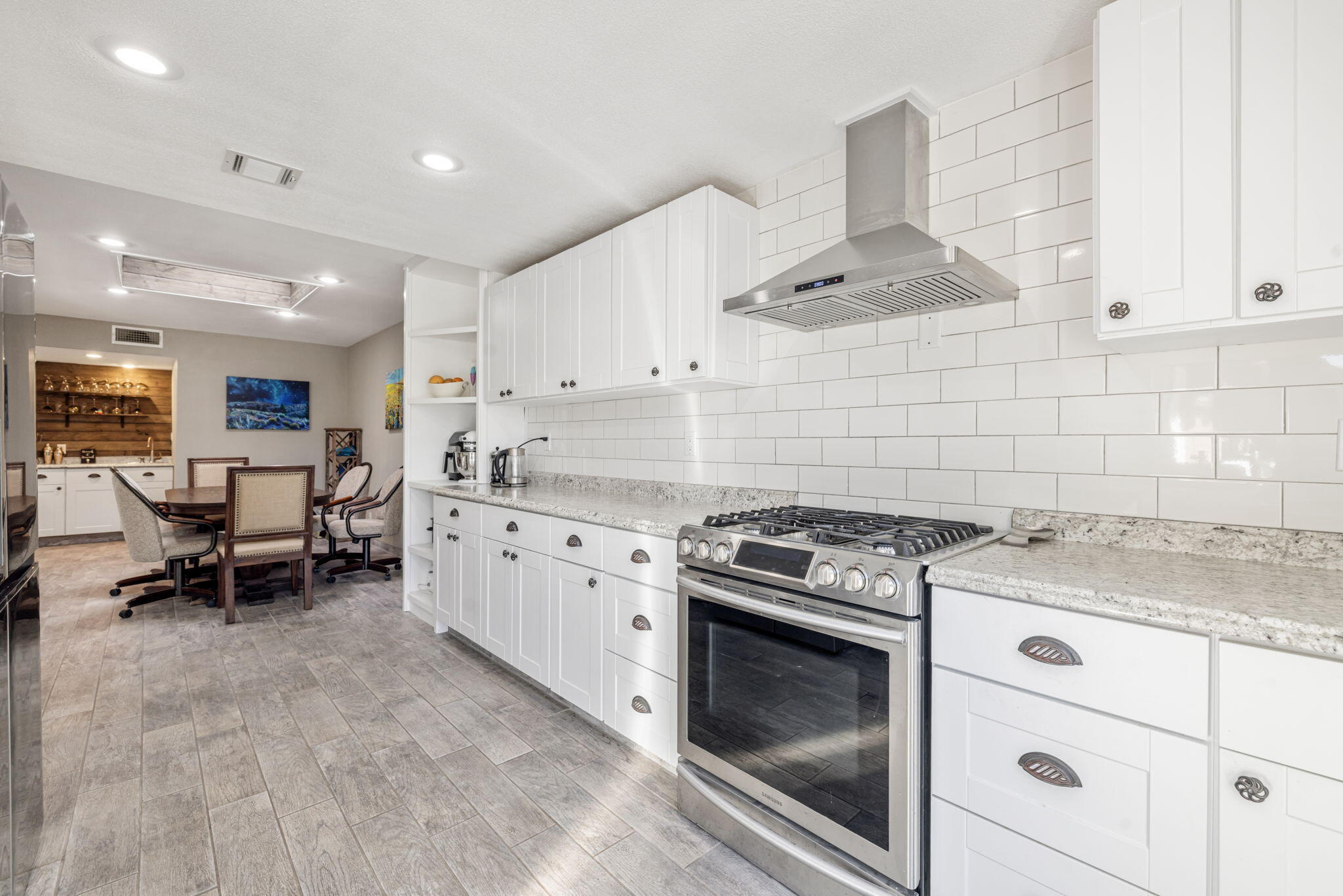 82191 Ullman Road Indio, CA 92201 - Photo 15 of 40 a kitchen with a stove white cabinets and white appliances