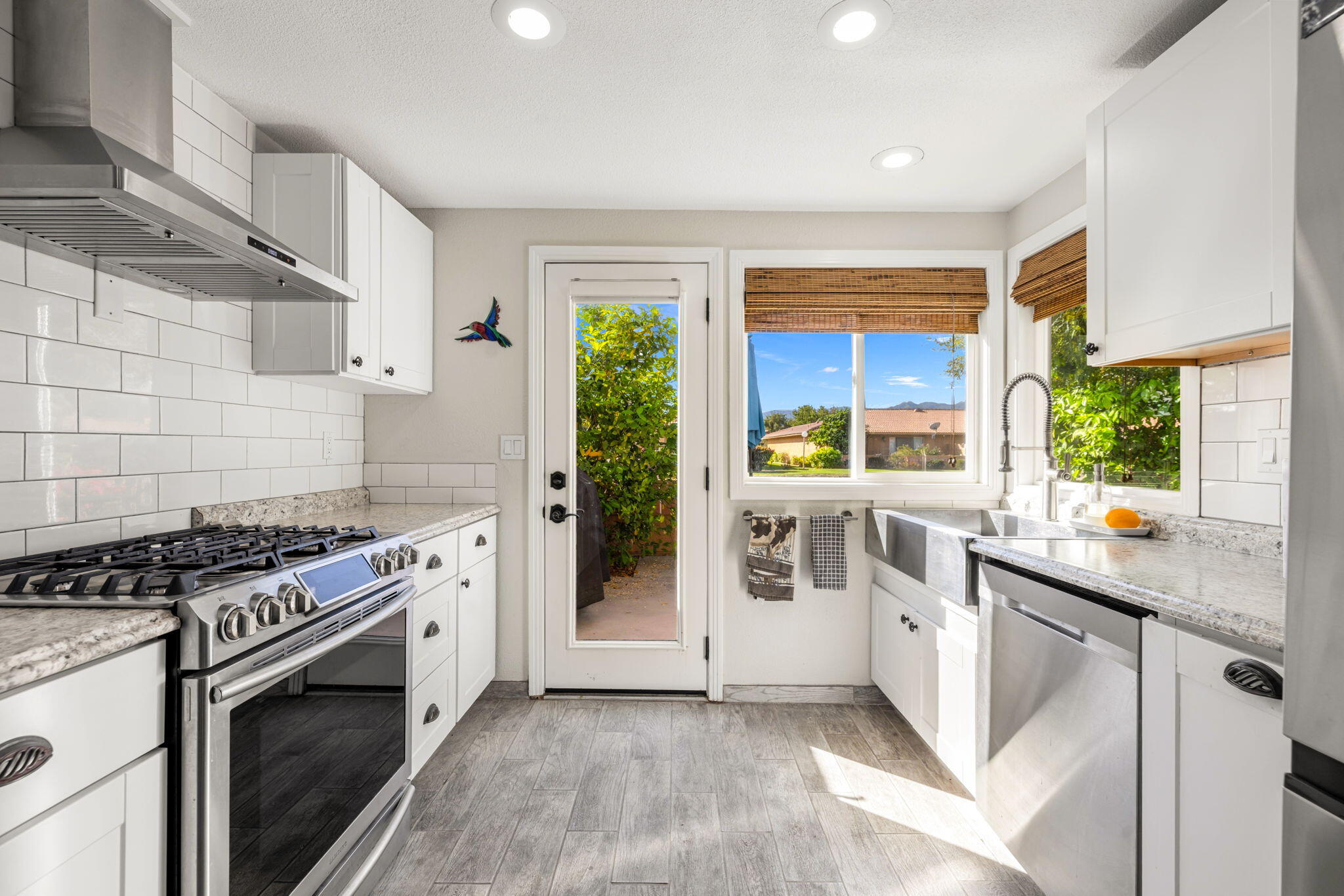 82191 Ullman Road Indio, CA 92201 - Photo 17 of 40 a kitchen with stainless steel appliances granite countertop a stove a sink and a refrigerator