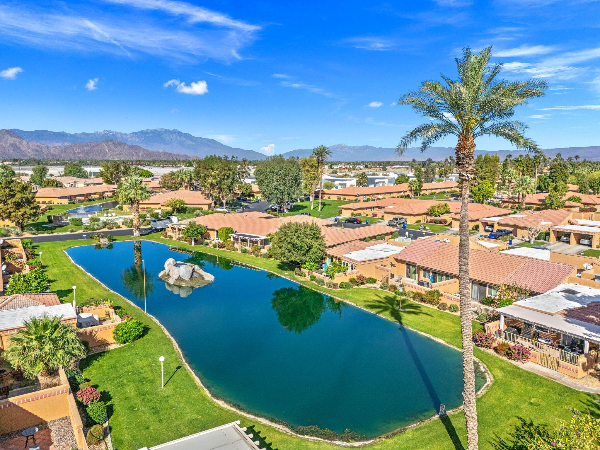 82191 Ullman Road Indio, CA 92201 - Photo 36 of 40 a view of a swimming pool with a lawn chairs under an umbrella