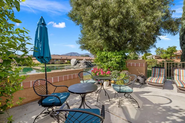 a view of a chairs and table in patio