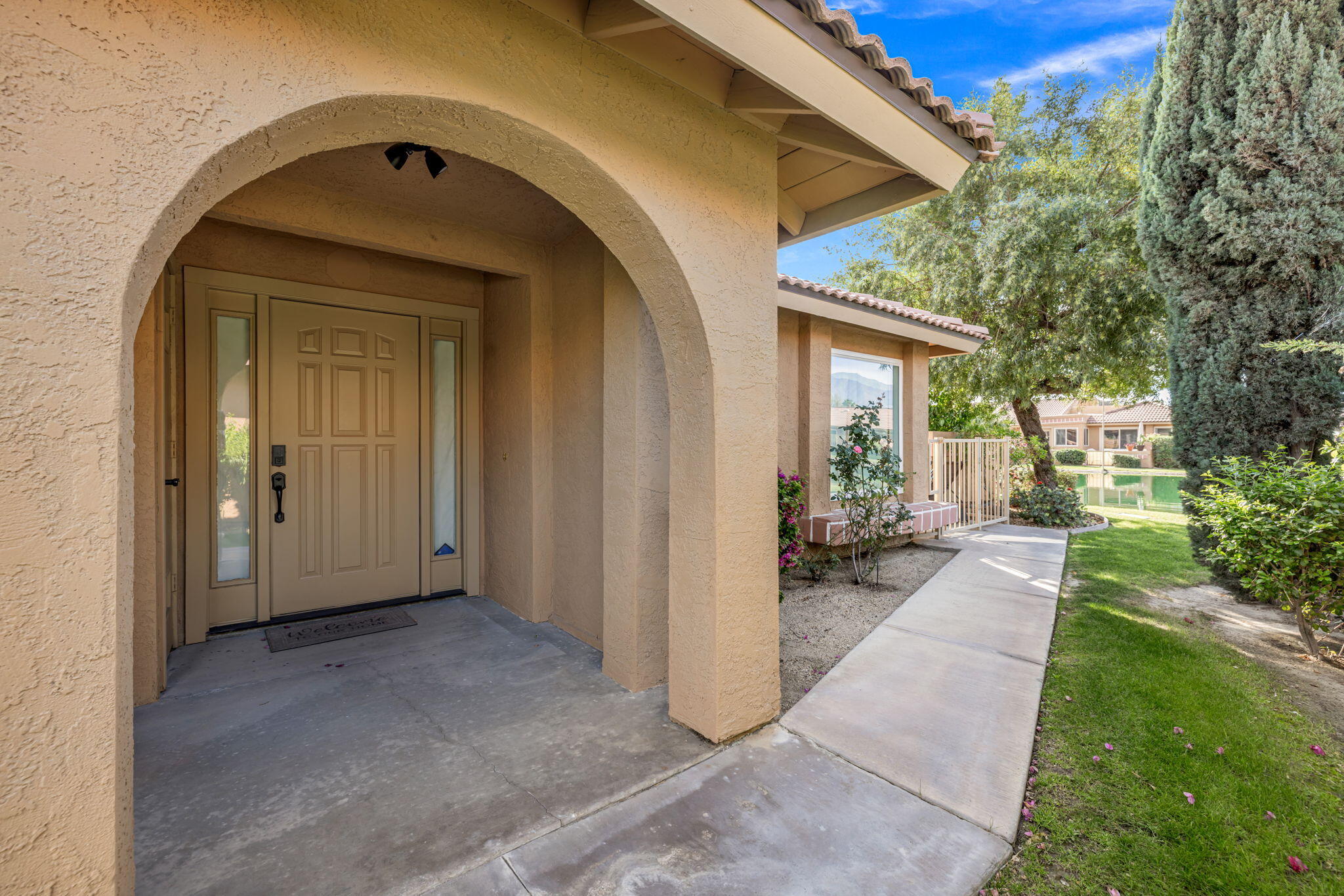 82191 Ullman Road Indio, CA 92201 - Photo 10 of 40 a view of a house with a glass door and a yard