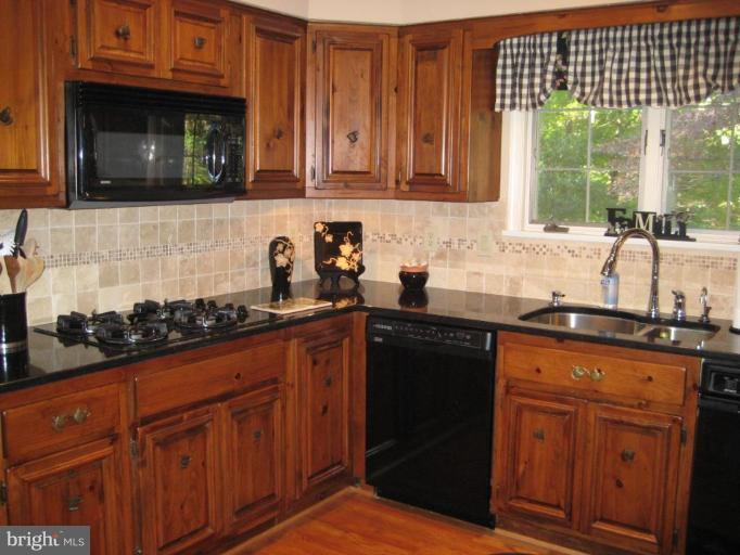 3491 Godspeed Road Davidsonville, MD 21035 - Photo 28 of 30 Gas cooktop, granite countertops, tile backsplash