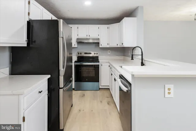 a kitchen with stainless steel appliances a sink stove and refrigerator