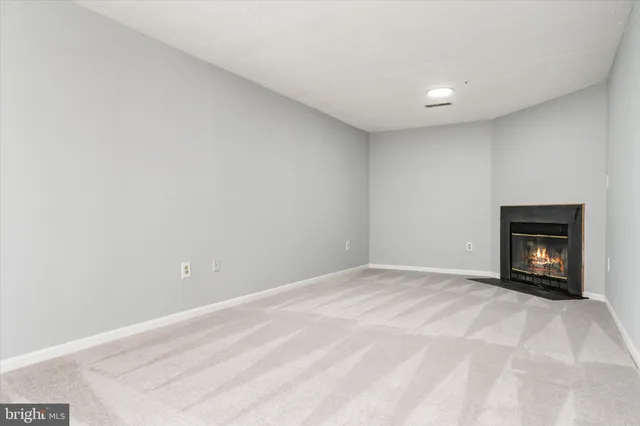 a view of an empty room with a fireplace
