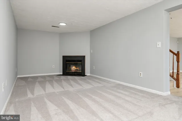 a view of empty room with a fireplace