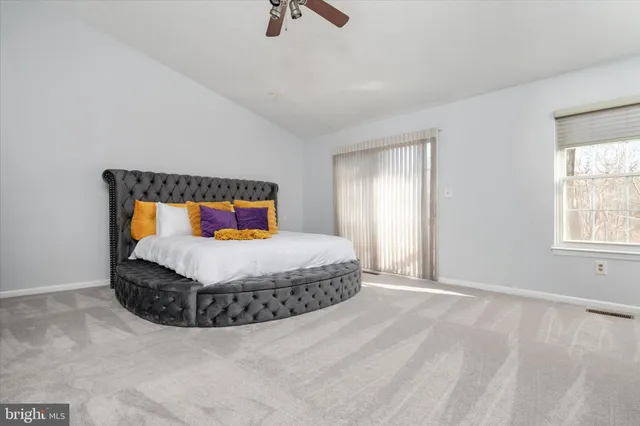 a bedroom with a bed and window