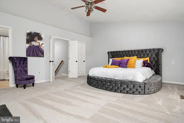 a bedroom with a bed and a painting on the wall