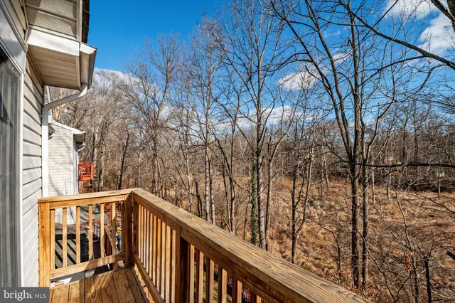 a view of balcony with wooden floor and fence