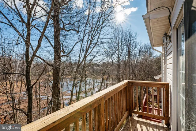a view of a white house with large windows next to a road