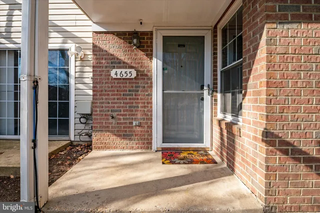 a view of a brick building with a door and a window